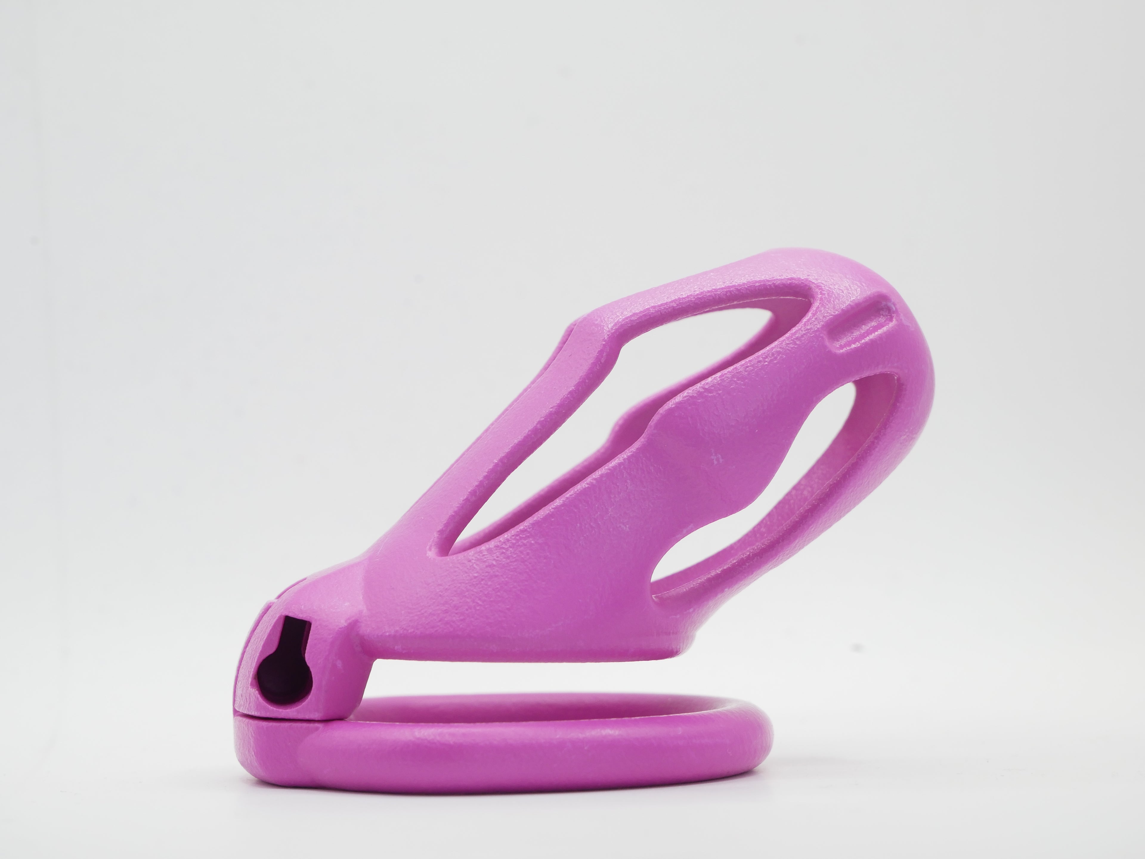 A pink chastity cage with an open design, featuring a front cap and a lockable mechanism.