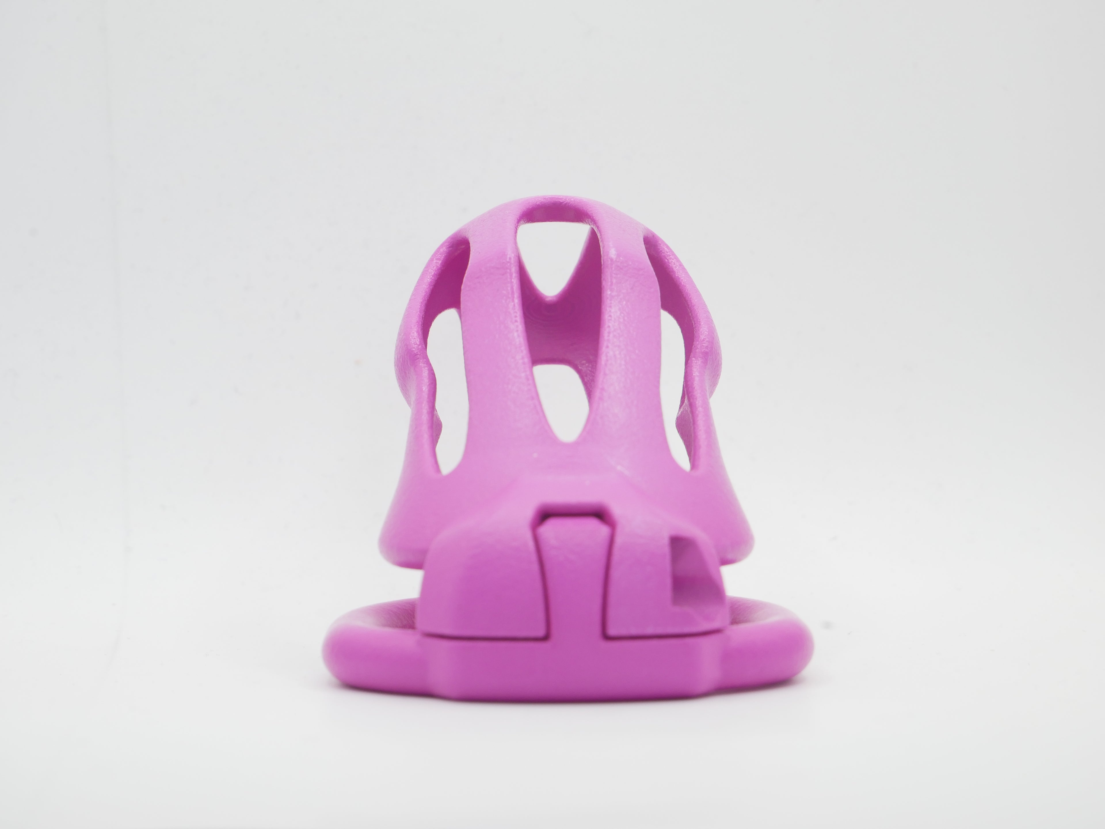 A pink chastity cage with an open design, featuring a front cap and a lockable mechanism.