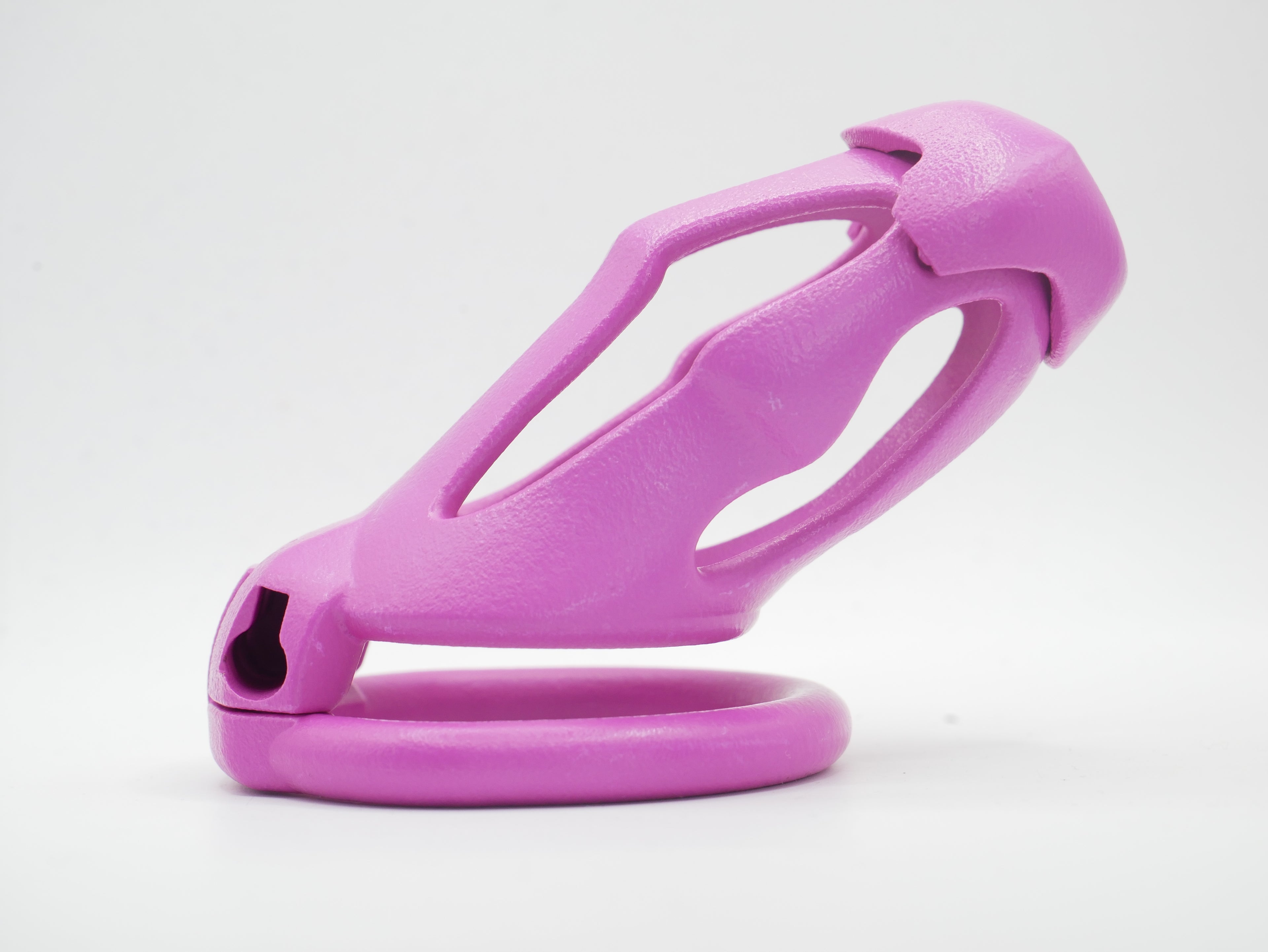 A pink chastity cage with an open design, featuring a front cap and a lockable mechanism.
